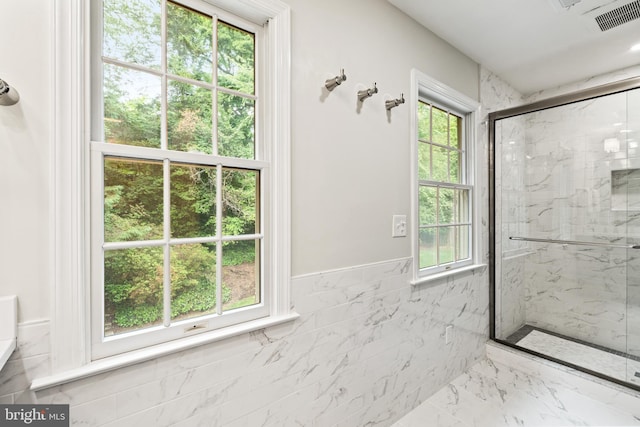 708 W Timber Branch Pkwy, Alexandria, VA 22302 - full bath with a marble finish shower, plenty of natural light, wainscoting, and marble finish floors