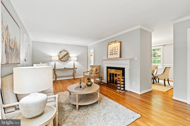 708 W Timber Branch Pkwy, Alexandria, VA 22302 - living area with wood finished floors, ornamental molding, a fireplace with flush hearth, and baseboards