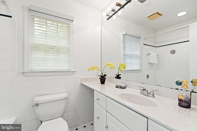 708 W Timber Branch Pkwy, Alexandria, VA 22302 - bathroom with toilet, vanity, tile walls, and a shower