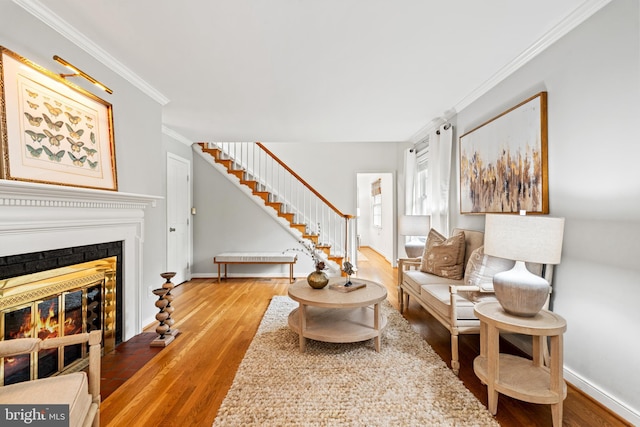 708 W Timber Branch Pkwy, Alexandria, VA 22302 - living room with wood finished floors, crown molding, stairs, baseboards, and a glass covered fireplace