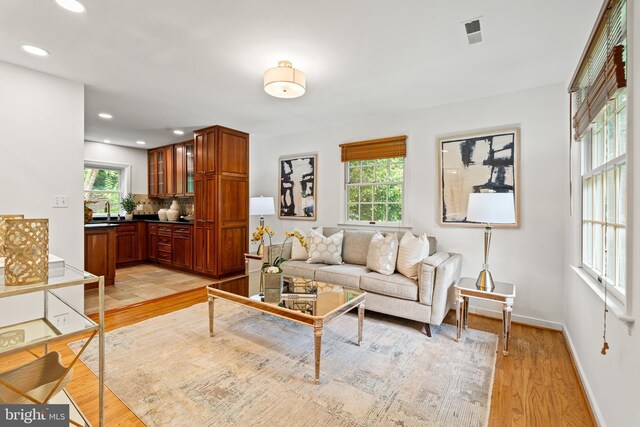 708 W Timber Branch Pkwy, Alexandria, VA 22302 - living area with light wood finished floors, baseboards, and recessed lighting