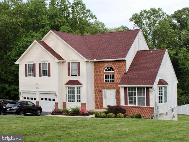 view of front of house with an attached garage, brick siding, driveway, a front lawn, and a shingled roof