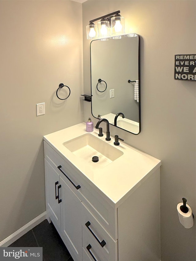 bathroom with baseboards, tile patterned flooring, and vanity