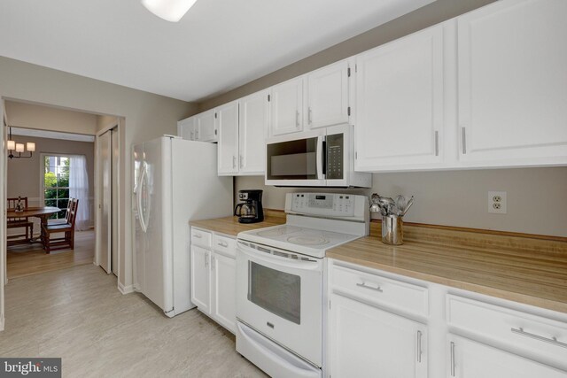 73 Mcpherson Cir, Sterling, VA 20165 - kitchen featuring white appliances, white cabinetry, light countertops, a chandelier, and light wood finished floors
