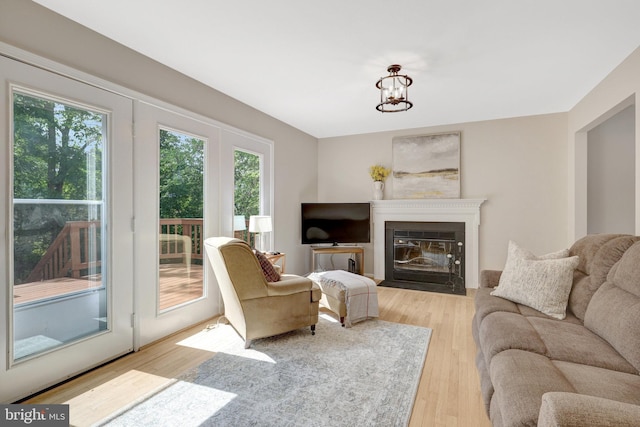 73 Mcpherson Cir, Sterling, VA 20165 - living room with light wood-type flooring, a fireplace with flush hearth, and a chandelier