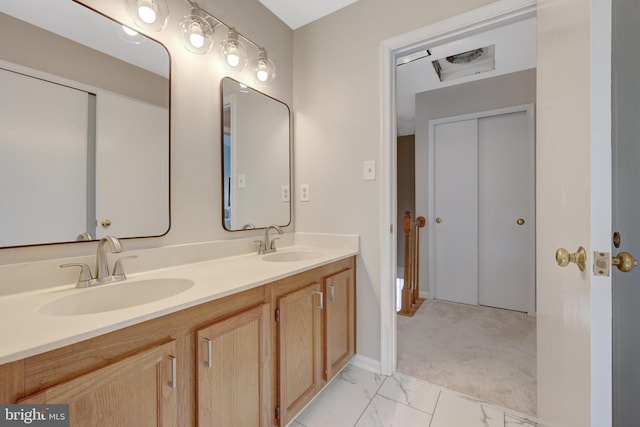 73 Mcpherson Cir, Sterling, VA 20165 - bathroom with double vanity, marble look tiles, and baseboards