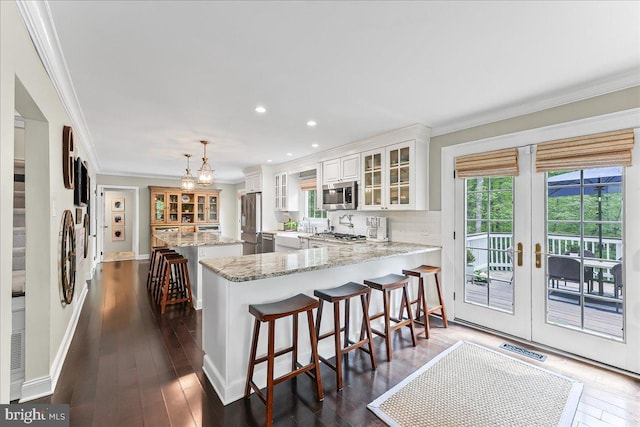 kitchen featuring a center island, ornamental molding, and stainless steel appliances
