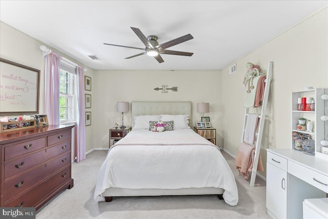 bedroom featuring visible vents, a ceiling fan, baseboards, and light carpet