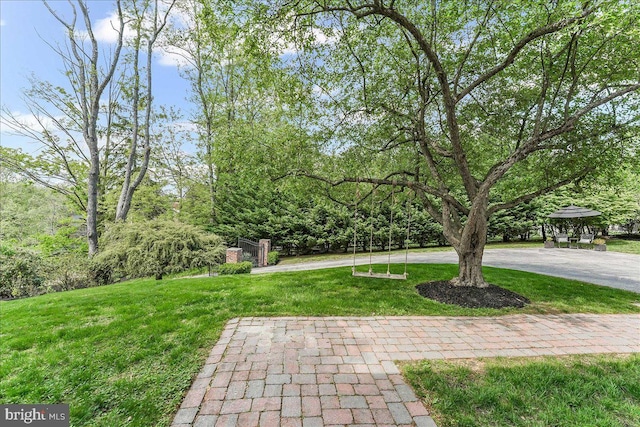 view of yard with curved driveway