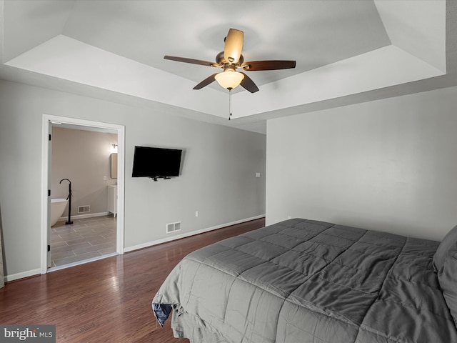 112 Rebels Cir, Winchester, VA 22602 - bedroom featuring a tray ceiling, wood finished floors, baseboards, ceiling fan, and ensuite bath