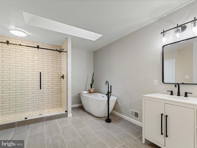 112 Rebels Cir, Winchester, VA 22602 - full bathroom featuring a skylight, a shower stall, a freestanding bath, vanity, and baseboards