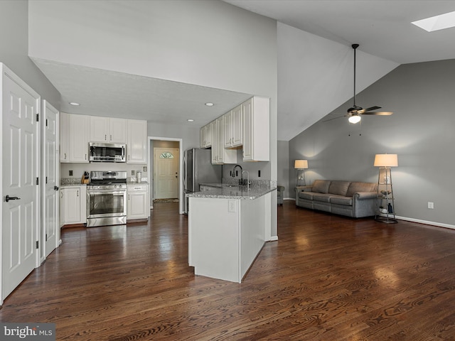 112 Rebels Cir, Winchester, VA 22602 - kitchen with stainless steel appliances, a skylight, open floor plan, light stone counters, and white cabinets