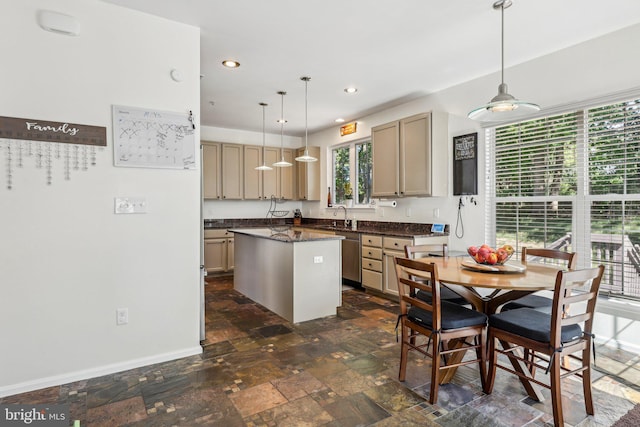 kitchen featuring dark countertops, a kitchen island, decorative light fixtures, dark stone finish floors, and recessed lighting
