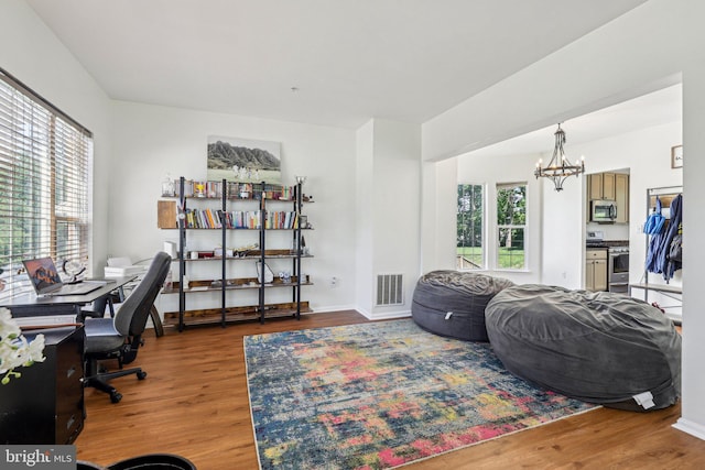 office with wood finished floors, a chandelier, and baseboards