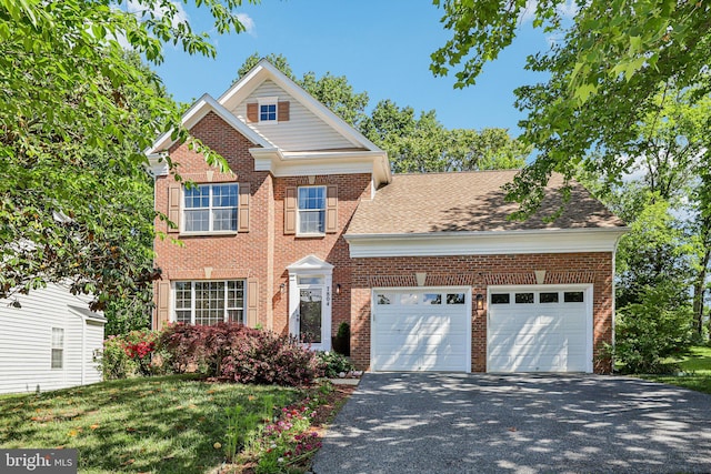 view of front facade featuring a garage, asphalt driveway, brick siding, and a front lawn