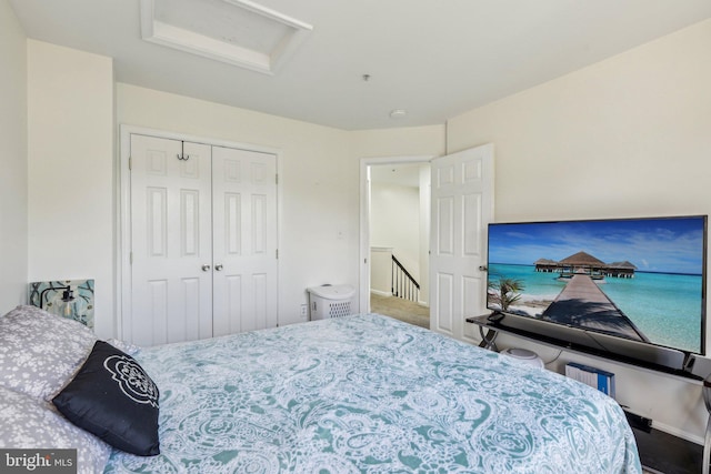 bedroom with attic access, a closet, and baseboards