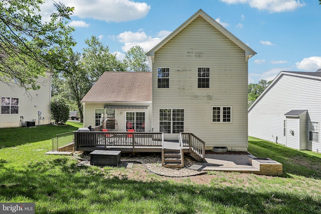 back of house with a wooden deck, a lawn, and cooling unit