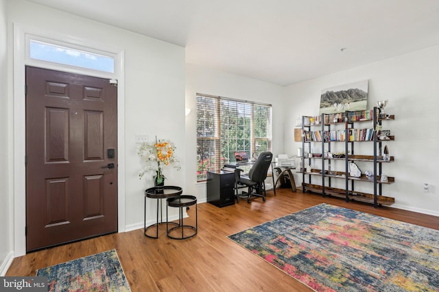 foyer entrance featuring wood finished floors and baseboards