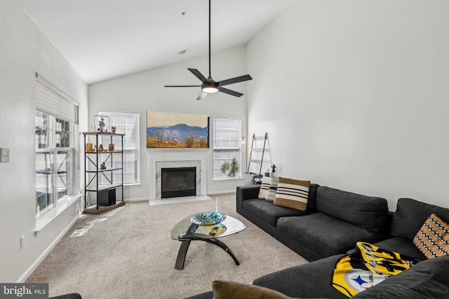 living room featuring carpet floors, vaulted ceiling, a premium fireplace, ceiling fan, and baseboards