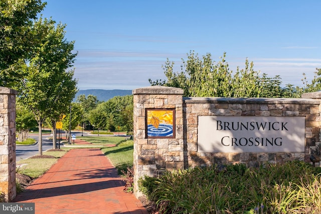 community sign with a mountain view