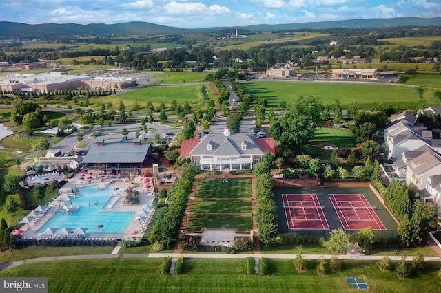 aerial view of a pool area and a mountainous background
