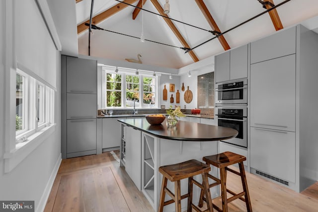 16 Southgate Ave, Annapolis, MD 21401 - kitchen with gray cabinetry, dark countertops, high quality fridge, modern cabinets, and light wood-style floors