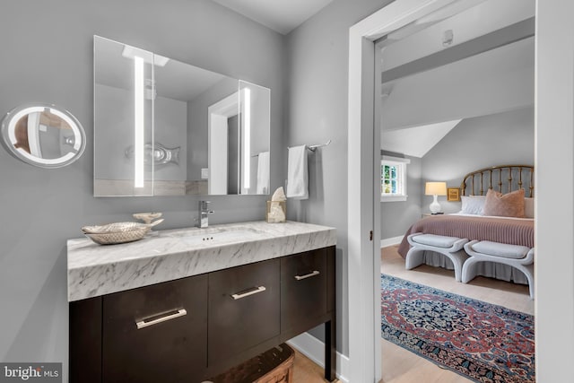 16 Southgate Ave, Annapolis, MD 21401 - bathroom featuring vanity, baseboards, lofted ceiling, ensuite bathroom, and wood finished floors