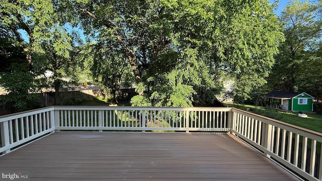wooden deck featuring an outbuilding