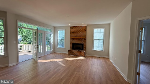 unfurnished living room featuring light wood-style floors and baseboards