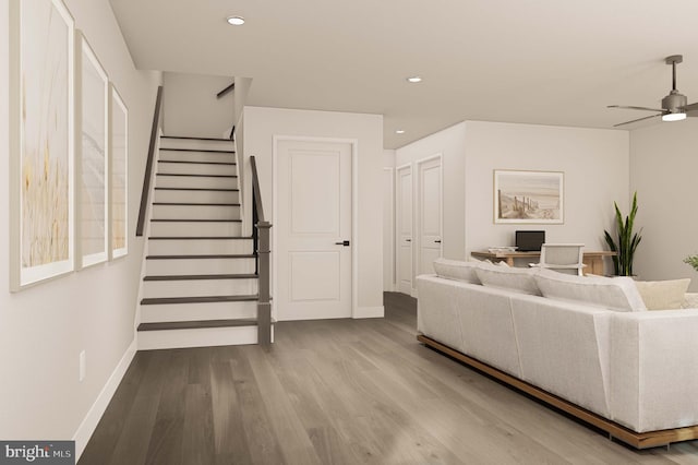 living area featuring a ceiling fan, baseboards, recessed lighting, and wood finished floors