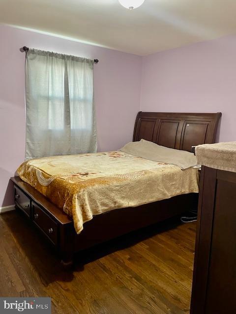 bedroom featuring dark wood-type flooring
