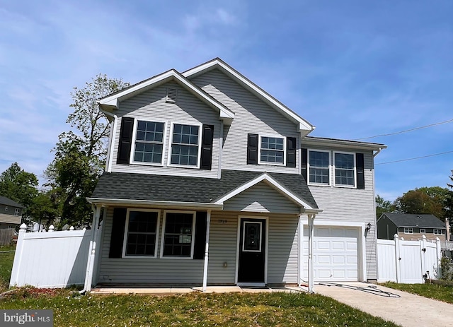 view of front of house with fence, covered porch, a gate, concrete driveway, and an attached garage