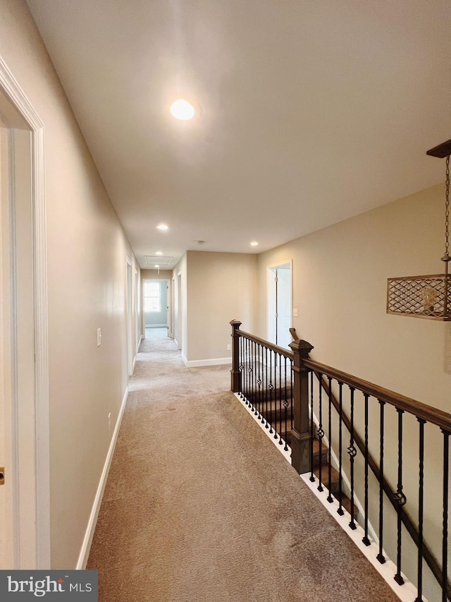 corridor with attic access, carpet, recessed lighting, baseboards, and an upstairs landing