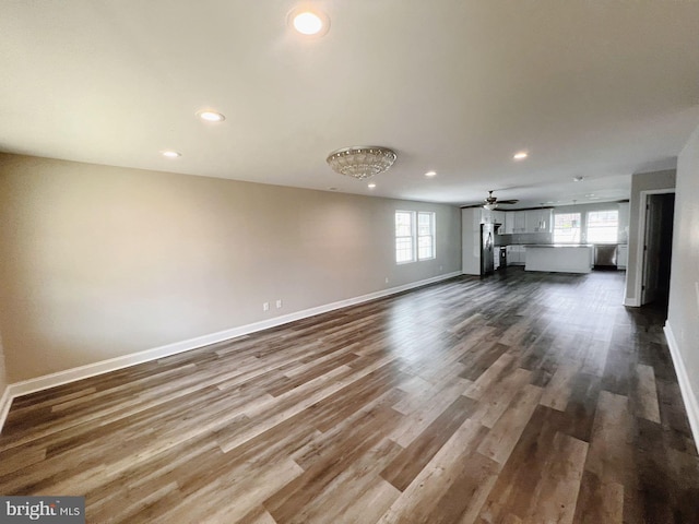 unfurnished living room with recessed lighting, baseboards, dark wood finished floors, and ceiling fan