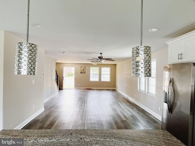 unfurnished living room featuring baseboards, a ceiling fan, dark wood-type flooring, and recessed lighting
