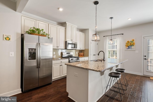 18095 Red Mulberry Rd, Dumfries, VA 22026 - kitchen with stainless steel appliances, a sink, tasteful backsplash, dark wood-style flooring, and baseboards