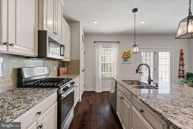 18095 Red Mulberry Rd, Dumfries, VA 22026 - kitchen with appliances with stainless steel finishes, a sink, dark wood-style flooring, baseboards, and tasteful backsplash
