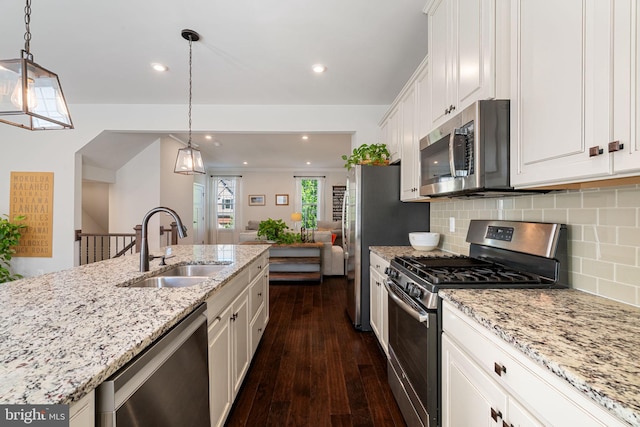 18095 Red Mulberry Rd, Dumfries, VA 22026 - kitchen with appliances with stainless steel finishes, a sink, dark wood finished floors, white cabinets, and decorative backsplash