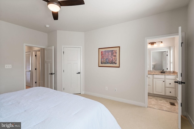 18095 Red Mulberry Rd, Dumfries, VA 22026 - bedroom with light colored carpet, baseboards, ensuite bathroom, and ceiling fan