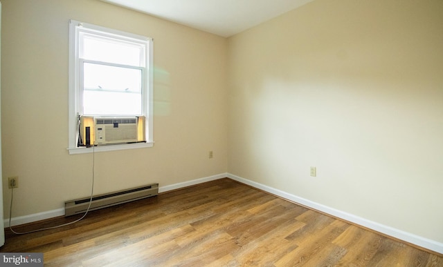 unfurnished room with a baseboard radiator, light wood-style flooring, baseboards, and cooling unit