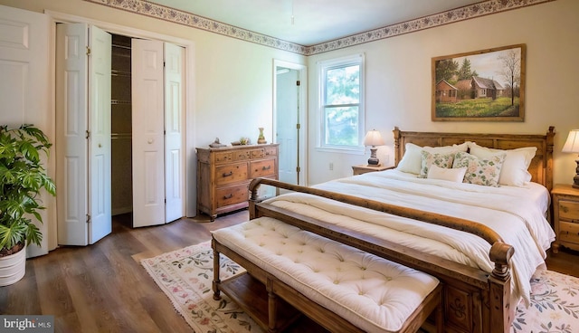 bedroom featuring wood finished floors and a closet