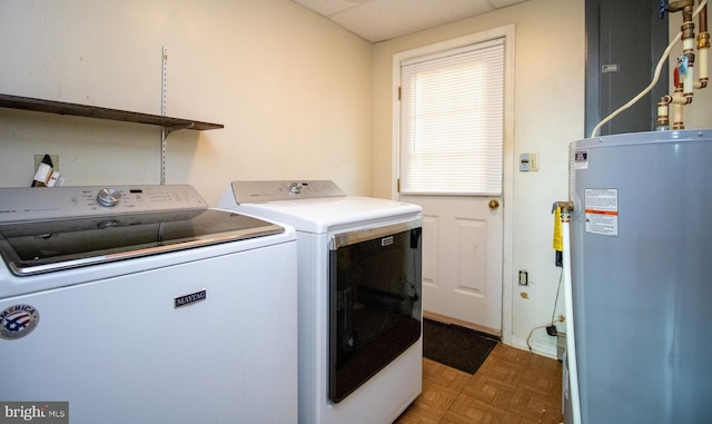 laundry area featuring water heater and washer and clothes dryer