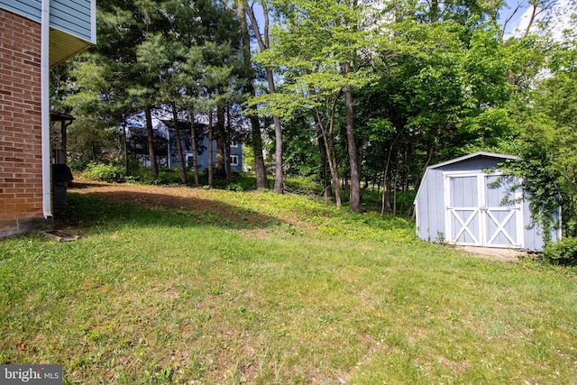 view of green lawn with a storage unit and an outbuilding