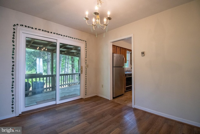 entryway featuring a chandelier, baseboards, wood finished floors, and a sink