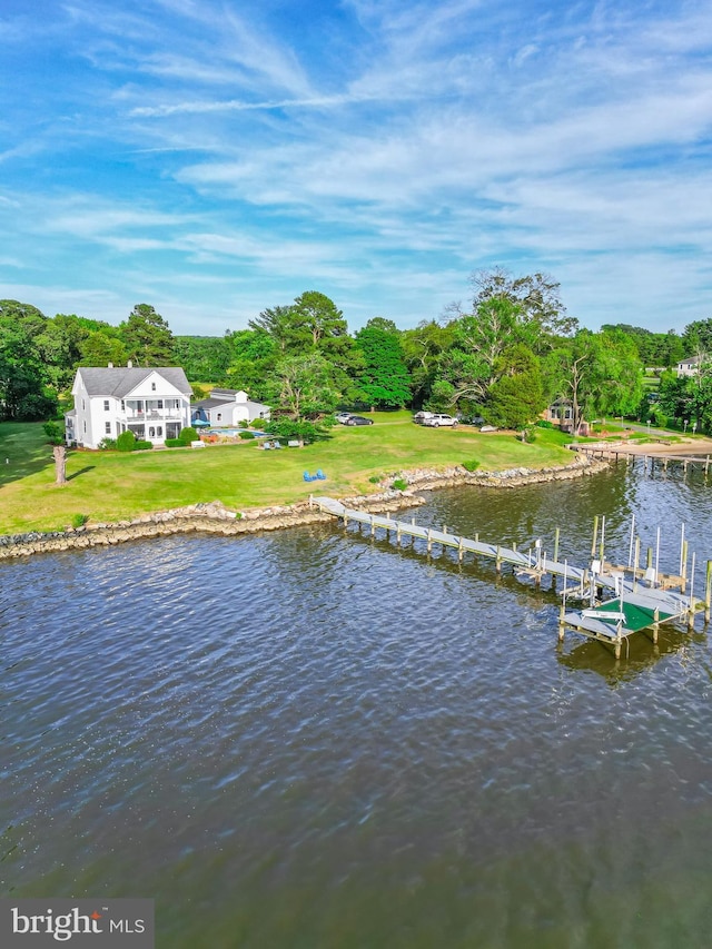 view of dock featuring a water view and a yard