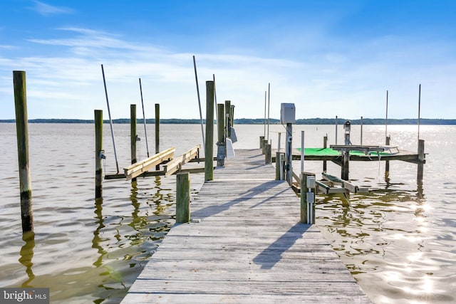 dock area with boat lift and a water view