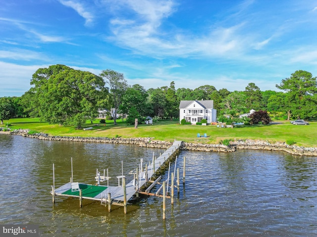 view of dock featuring a water view and a yard