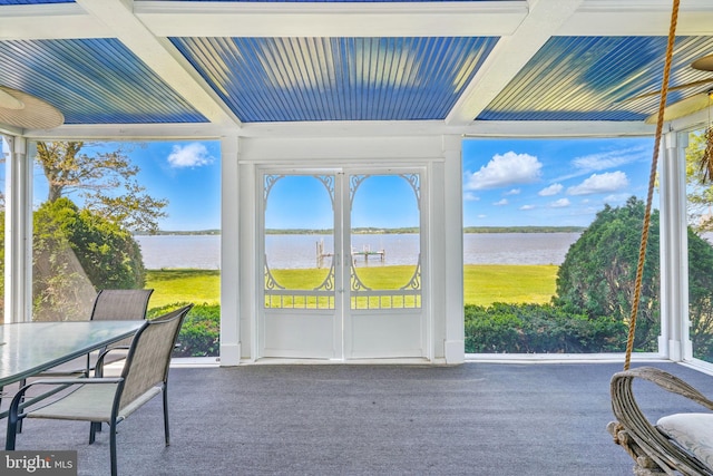 sunroom / solarium with a water view, coffered ceiling, and beam ceiling