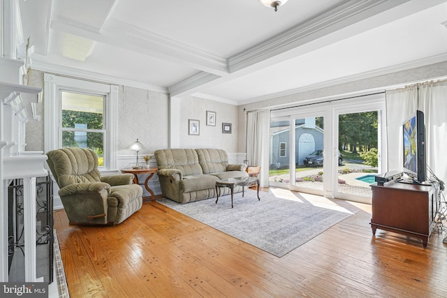 living area featuring crown molding, beamed ceiling, hardwood / wood-style flooring, and french doors