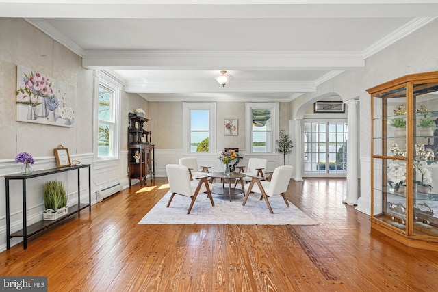 dining area featuring decorative columns, arched walkways, wood finished floors, beamed ceiling, and ornamental molding